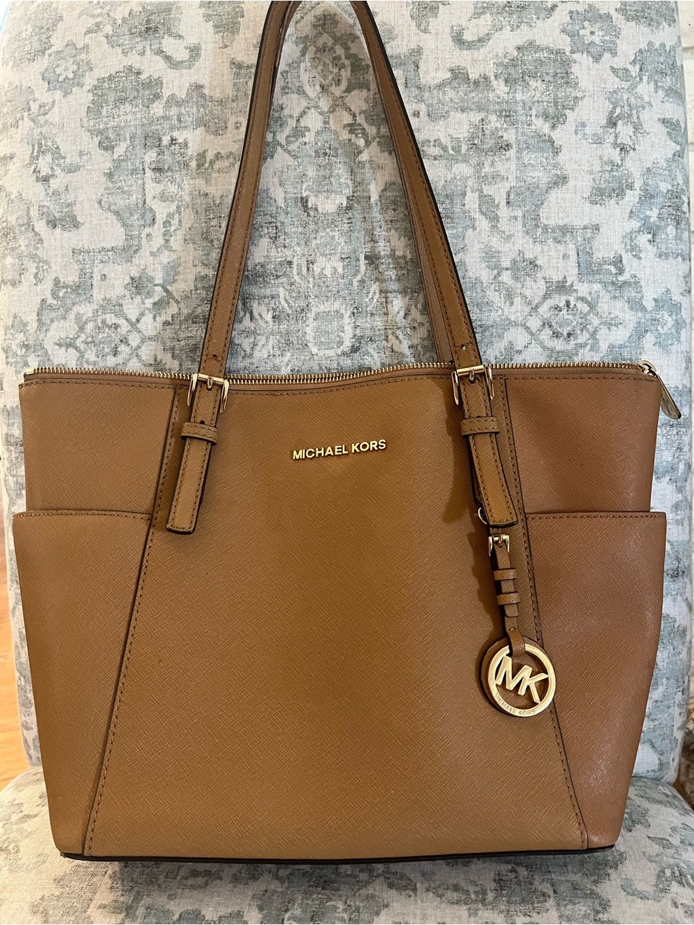 Michael Kors Cognac Saffiano Tote w/ Gold Accent and MK charm. Approx 10” by 15”